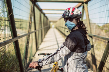 Biker with face mask training sport in pandemic time © FotoAndalucia