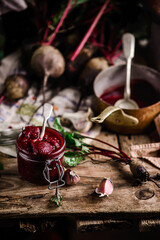Homemade beet ketchup in a glass jar. Rustic style