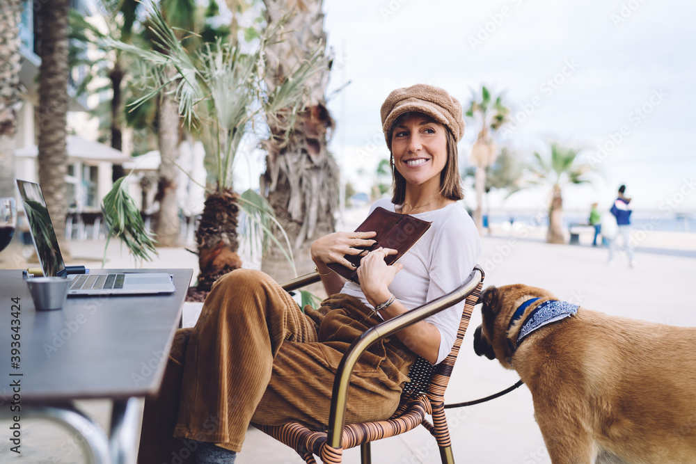 Aufkleber joyful caucasian female blogger holding notepad satisfied with creating articles for share in social