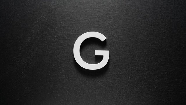 English alphabet letters appearing one by one. Black background. Stop motion.