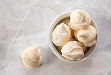Meringues on the marble background, top view
