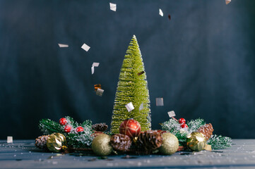 Festive composition for new year and christmas. Christmas tree with decoration on a wooden table.