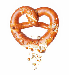 Freshly baked pretzel broken in the air on a white background