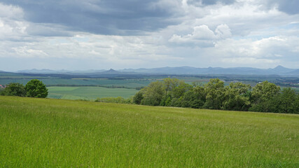 Czech Central Mountains (Ceske stredohori) with meadows and volcanoes hills panoramic view