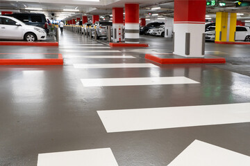 Parking garage - interior shot of multi-story car park, underground parking with cars. Parking...