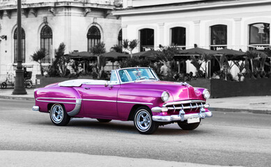 colorkey of pink classic convertible car in the streets of havana cuba - obrazy, fototapety, plakaty