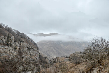 mountains, clouds, trees and houses