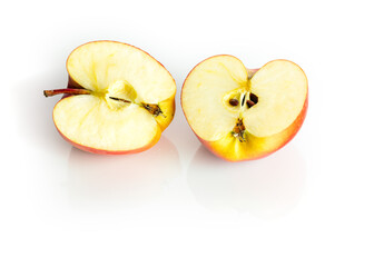 Two halves of an bio healthy apple, isolated on white background with reflections. Tasty fruit for breakfast. Vitamins in the eco fruits. Organic apples from eco farm isolated on white background.