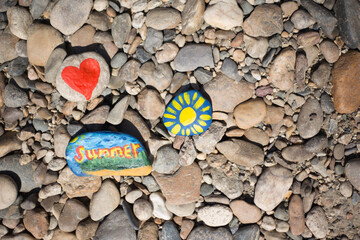 Hand-painted stone with paints and gouache with summer patterns