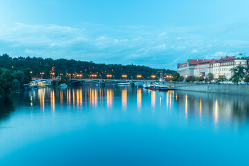 Fototapeta na wymiar Vltava river with bridge in the dusk in Prague, Czech Republic.