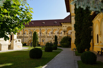 Alba Iulia, Romania - September 20, 2020: The inner court of the Coronation Cathedral. The buildings in neo-Brancoveanu style represent the headquarters of the Orthodox Archdiocese of Alba Iulia