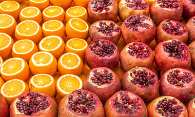 Fresh pomegranate and orange on the counter