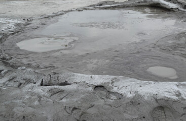 Bubbling crater of a mud volcano. Close up view onto gas bubble exploding in crater of mud volcano. Mud volcano at Paclele Mari, near Buzau, Romania.