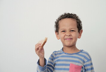 little boy eating toast for breakfast on white background stock photo