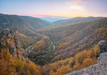 Amazing panoramic view from Tumba vantage point on a canyon with meandering river Temstica, autumn colored trees and a rocky summit - 393660814
