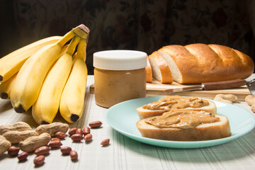 Peanut butter, loaf, banana . Breakfast with peanut butter. Healthy snack - vegetarian bread loaf with peanut butter and banana