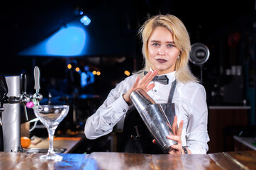 Girl barman creates a cocktail at the beerhall © Mr. Prof