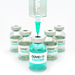 Small bottles of Covid-19 vaccine and medical injection above on bright background. Digital 3D illustration for health care theme and pandemic situation.