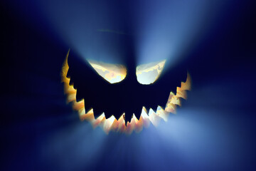 Halloween pumpkin glowing face in the dark.