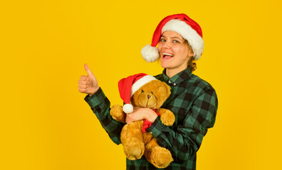 Christmas spirit. Playful lady smiling face. Play with toy. Santa Claus. Pretty woman celebrate christmas. Christmas memories from childhood. Girl with teddy bear. Charity and kindness. Lovely hug