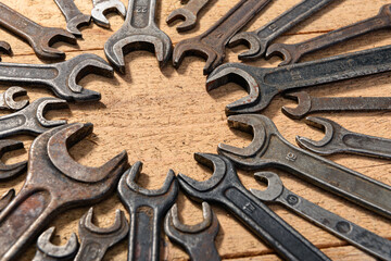 old vintage hand tools - set of wrenches on a wooden background with blank space for text