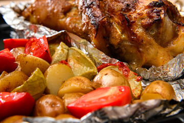baked meat and potatoes on a baking sheet, pork knuckle delicious food