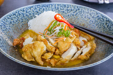 Thai style breaded chicken breast in curry sauce