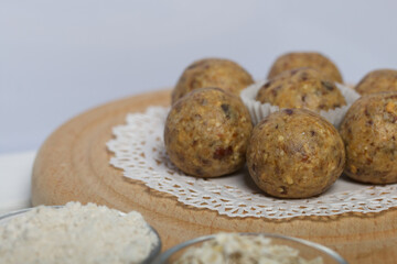 Dried fruit and oatmeal sweets. On a white wooden box. Close-up shot.