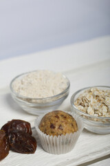 Dried fruit and oatmeal sweets. Nearby ingredients for their preparation. On a white wooden box.