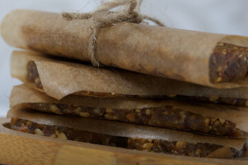 Nut & Dried Fruit Energy Bars. Wrapped in paper and tied with twine. Close-up shot.