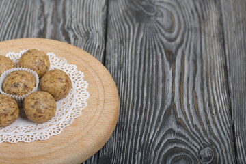 Dried fruit and oatmeal sweets. On black pine boards. Close-up shot.