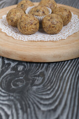 Dried fruit and oatmeal sweets. On black pine boards. Close-up shot.