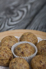 Dried fruit and oatmeal sweets. On black pine boards. Close-up shot.