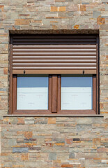 Wooden windows with open shutters on brick facade