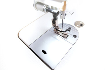 working area of a modern industrial sewing machine for highspeed production of clothing in bright white light