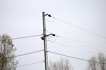 pole with power lines against the sky