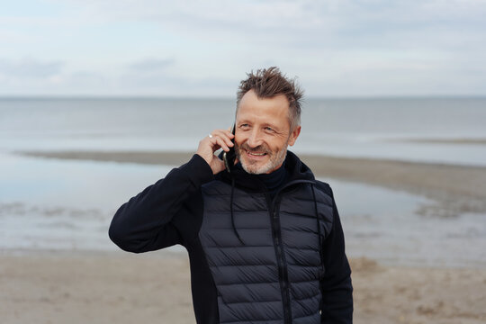 Man standing chatting on a mobile phone