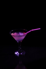 Cocktail with ice in a transparent glass on a black background