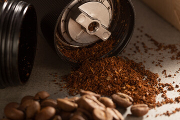 black modern manual coffee grinder and beans