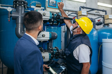 industrial worker inspecting chemical treatment equipment