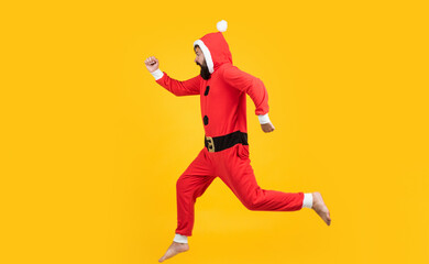 Fototapeta na wymiar Christmas Eve. happy bearded man hipster wear red festive elf costume. mature santa claus jumping. funny winter holiday celebration. feel free. happy new 2021 year. merry christmas. xmas party fun