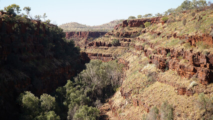 Arid dry red rock landscapes at Dales Gorge within Karijini National Park in the Hamersley Range of Western Australia.