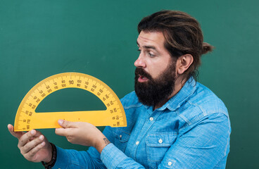 man surprised with size measured on protractor ruler math tool, school stem disciplines