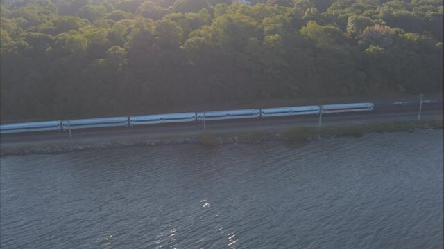 Aerial Drone Shot Tracking Train Approaching New York City Along Hudson River