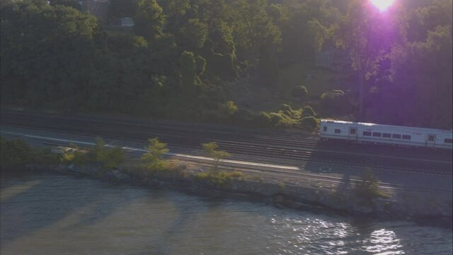 Aerial Drone Shot Tracking Train Leaving New York City Along Hudson River