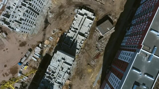 Aerial top down of construction site with cranes. Building of multistory houses in new residential area. Concept of architecture