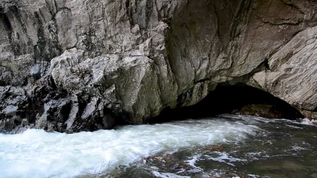 Disappearing River in Karst. Estavelle. River disappears into a cave. Cascading river flowing into abyss. Ponor