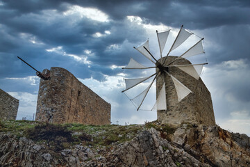 Beautiful jib sail windmills, used to pump water in arid zones, particularly found all around the Lassithi Plateau on the Island of Crete, Greece - obrazy, fototapety, plakaty