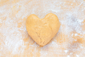 Christmas, Valentine's day food. Heart shaped gingerbread cookie dough on a rolling board. Homemade food.