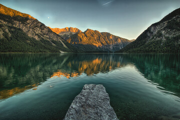 A mountain panorama with a view of the Alps and the Zugspitze with a mountain lake. A picturesque landscape that reflects the beauty of the German mountain. 